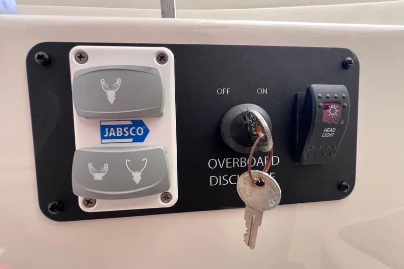 Slide: The Image of Control panel of 2017 World Cat Glacier Bay Edition 2740, featuring Jabsco switches and headlight control. - 55