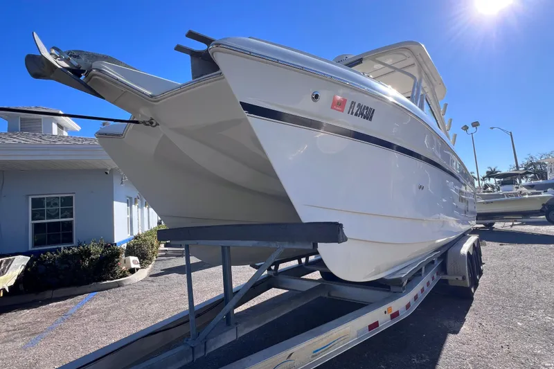 Slide: The Image of 2017 World Cat Glacier Bay Edition 2740 Dual Console boat on trailer, sunny day. - 6