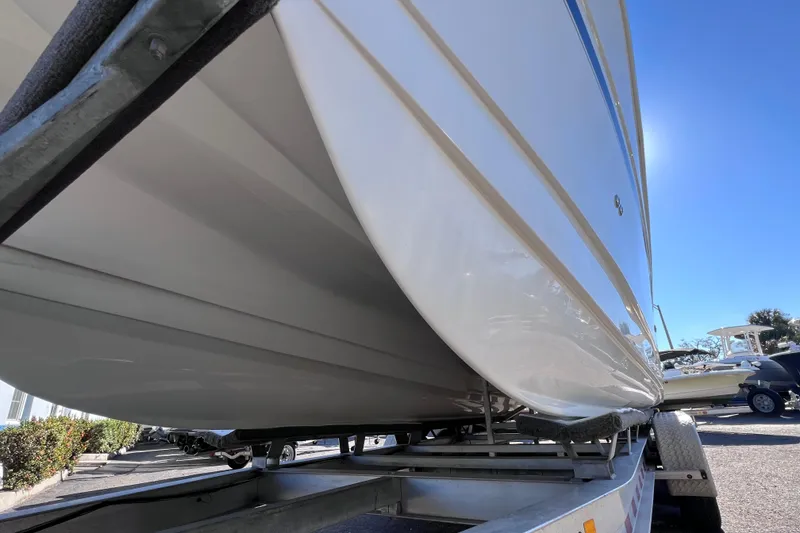 Slide: The Image of 2017 World Cat Glacier Bay Edition 2740 Dual Console boat on trailer, sunny day. - 8