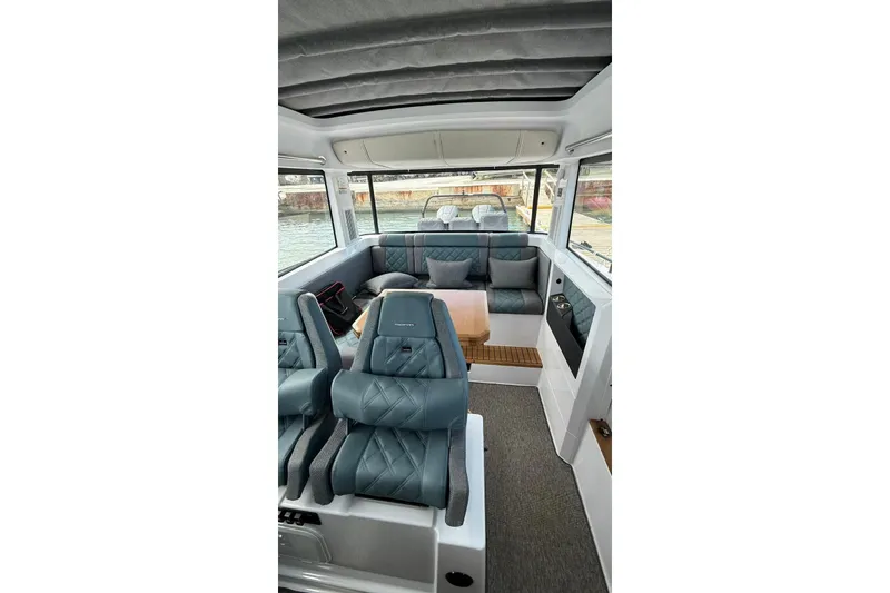 Slide: The Image of Interior of 2025 Axopar 37 XC Cross Cabin with luxurious seating and modern design. - 4