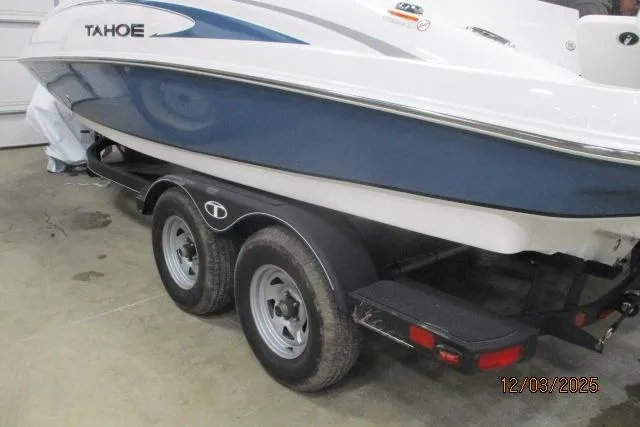 The Image of 2024 Tahoe 2150 CC boat on trailer, blue and white design, indoor storage. - 0
