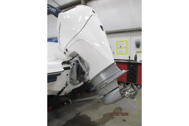 Slide: The Image of 2024 Tahoe 2150 CC boat with Mercury outboard motor in a workshop setting. - 3