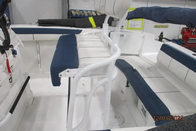 Slide: The Image of 2024 Tahoe 2150 CC boat interior with blue and white seating, showcasing spacious design. - 4