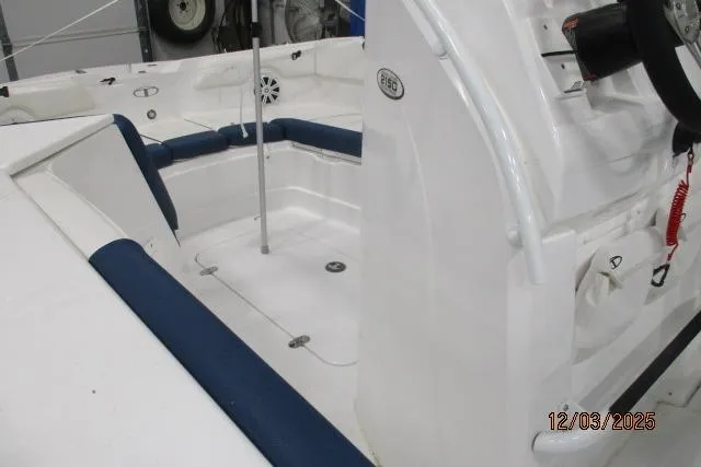 Slide: The Image of 2024 Tahoe 2150 CC boat interior with blue seating and steering console. - 5