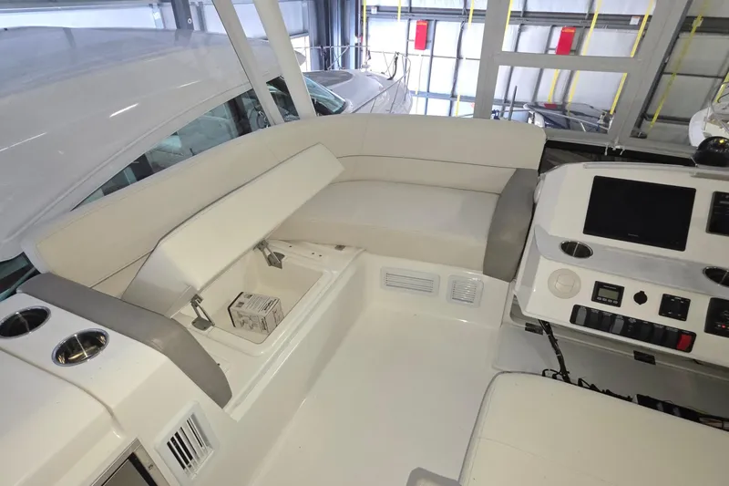 Slide: The Image of 2020 Tiara Yachts F44 Flybridge interior with seating and control panel. - 17