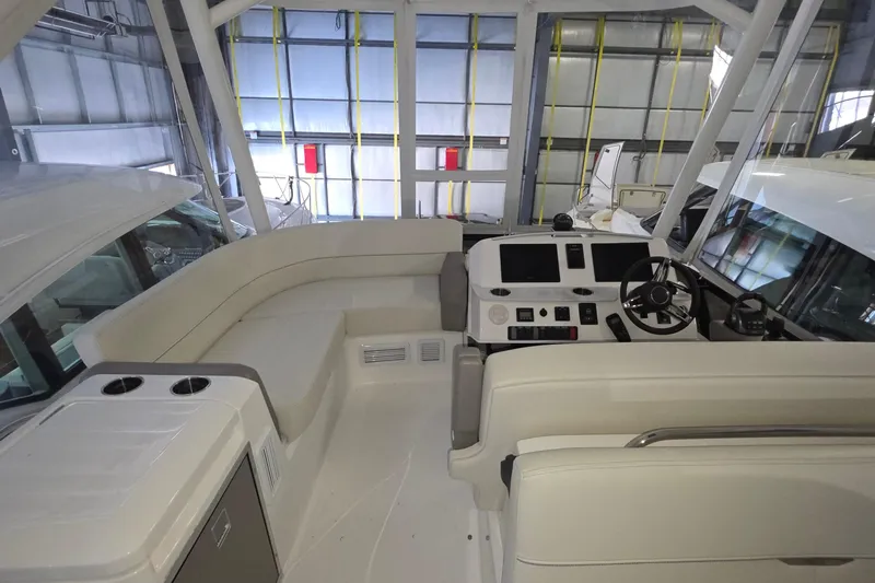 Slide: The Image of 2020 Tiara Yachts F44 Flybridge interior with helm and seating area. - 19