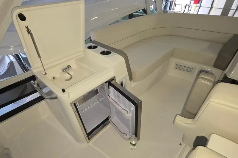 Slide: The Image of 2020 Tiara Yachts F44 Flybridge interior with sink, mini-fridge, and seating area. - 20