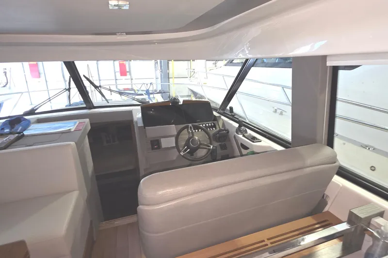 Slide: The Image of Interior of 2020 Tiara Yachts F44 Flybridge, featuring helm station and seating area. - 26