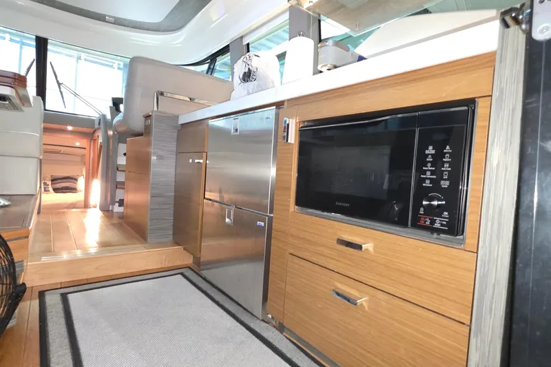 Slide: The Image of 2020 Tiara Yachts F44 Flybridge interior with modern kitchen and wood cabinetry. - 29