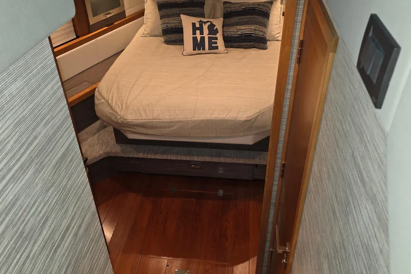 Slide: The Image of 2020 Tiara Yachts F44 Flybridge cabin with cozy bed and decorative pillows. - 34