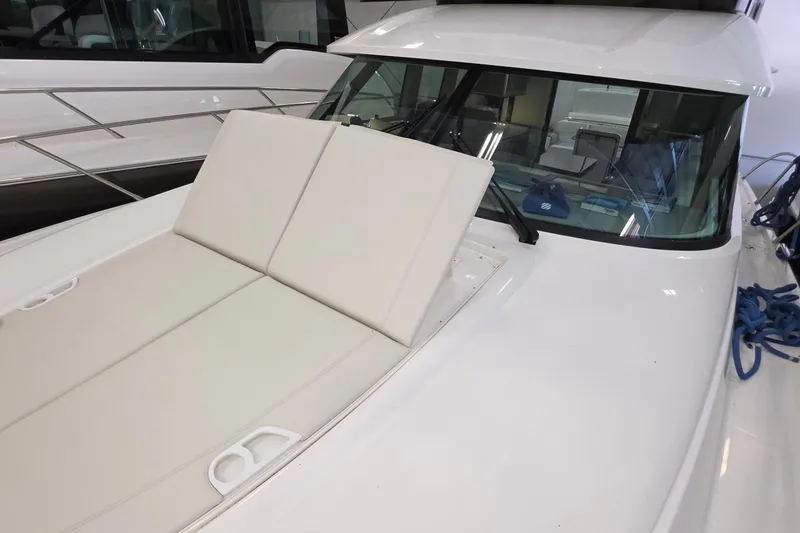 Slide: The Image of 2020 Tiara Yachts F44 Flybridge with white cushioned deck and windshield. - 50