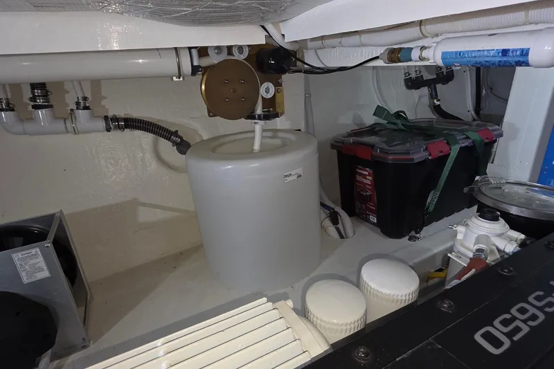 Slide: The Image of Engine room of 2020 Tiara Yachts F44 Flybridge with equipment and storage. - 55