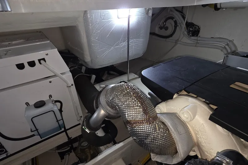 Slide: The Image of Engine room of 2020 Tiara Yachts F44 Flybridge, showcasing mechanical components and wiring. - 56