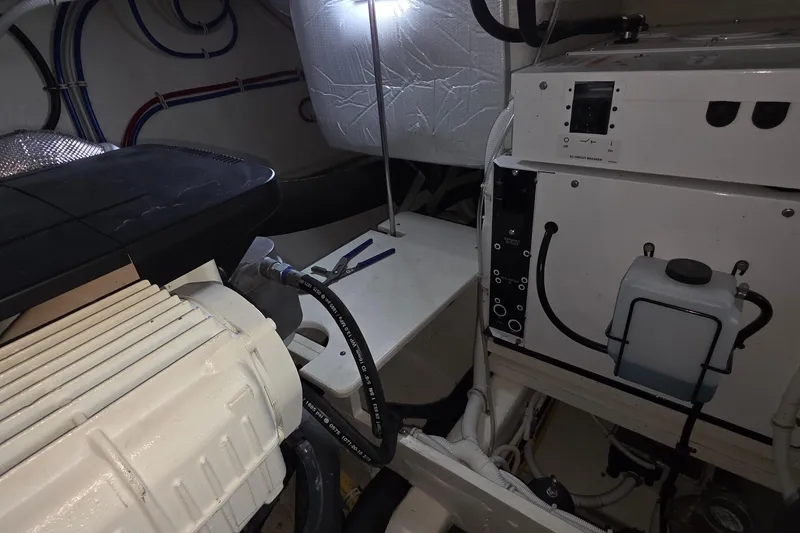Slide: The Image of Engine room of 2020 Tiara Yachts F44 Flybridge, showcasing mechanical components and wiring. - 58