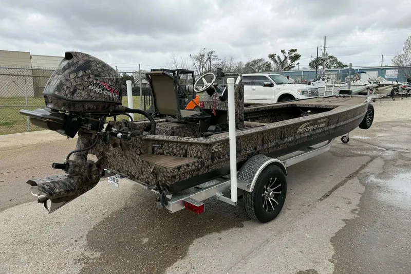 Slide: The Image of 2026 Pro-Drive 2054 X Series TD boat on trailer, featuring camo design and powerful outboard motor. - 3