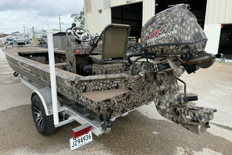Slide: The Image of Camouflage-patterned 2026 Pro-Drive 2054 X Series TD boat on trailer, featuring XRF 50 engine. - 4