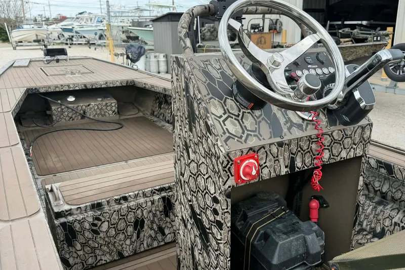 Slide: The Image of Pro-Drive 2054 X Series TD 2026 boat with camouflage design and modern steering console. - 5