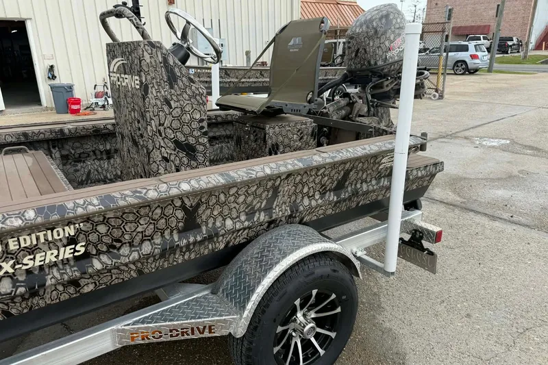Slide: The Image of 2026 Pro-Drive 2054 X Series TD boat with camouflage design on a trailer. - 8