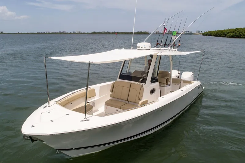 Slide: The Image of 2026 Pursuit S 288 Sport boat on water with fishing rods and canopy. - 17