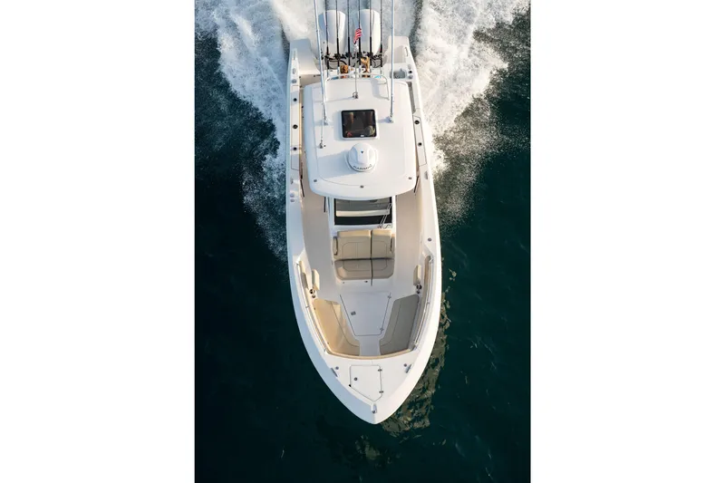 Slide: The Image of 2026 Pursuit S 288 Sport boat cruising on open water, aerial view. - 5