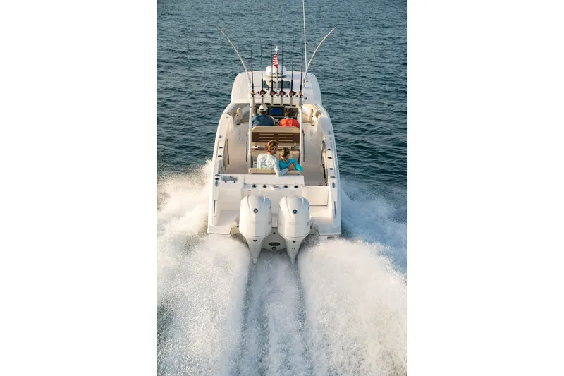 Slide: The Image of 2026 Pursuit S 288 Sport boat cruising on open water, rear view. - 6