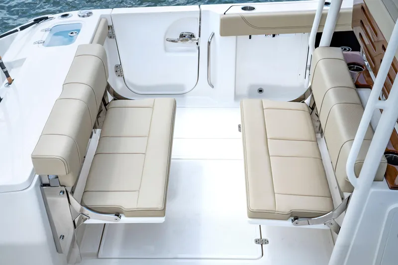 Slide: The Image of 2026 Pursuit S 288 Sport boat interior with beige seating and sleek design. - 8