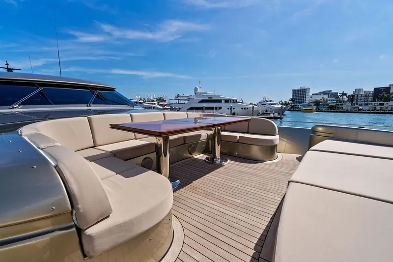 Slide: The Image of Luxurious 2013 AB 116 Motoryacht deck with elegant seating and table, docked in a marina. - 11