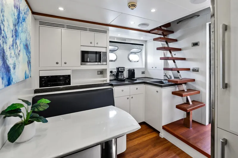 Slide: The Image of Modern kitchen interior on 2013 AB 116 Motoryacht with sleek cabinetry and wooden stairs. - 32