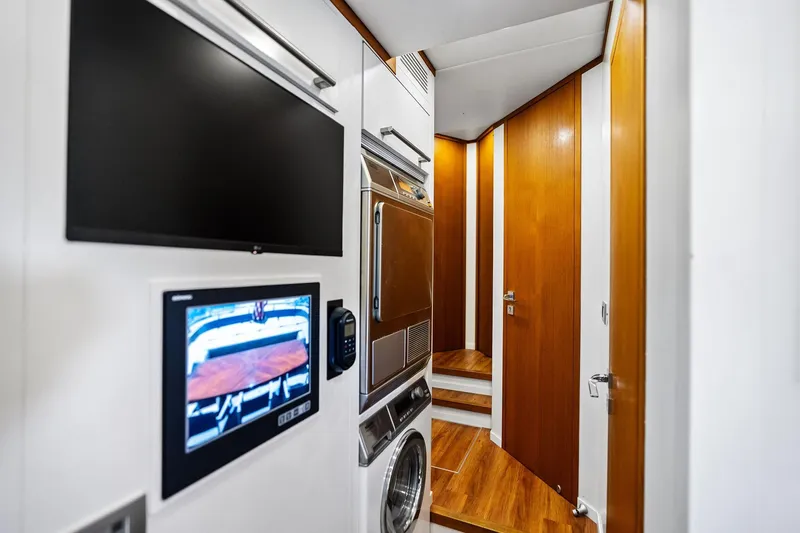 Slide: The Image of Laundry area in 2013 AB 116 Motoryacht with wood paneling and modern appliances. - 36