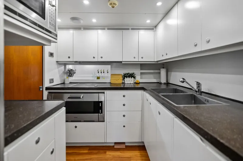 Slide: The Image of Modern kitchen in 2013 AB 116 Motoryacht with sleek white cabinetry and stainless steel appliances. - 37