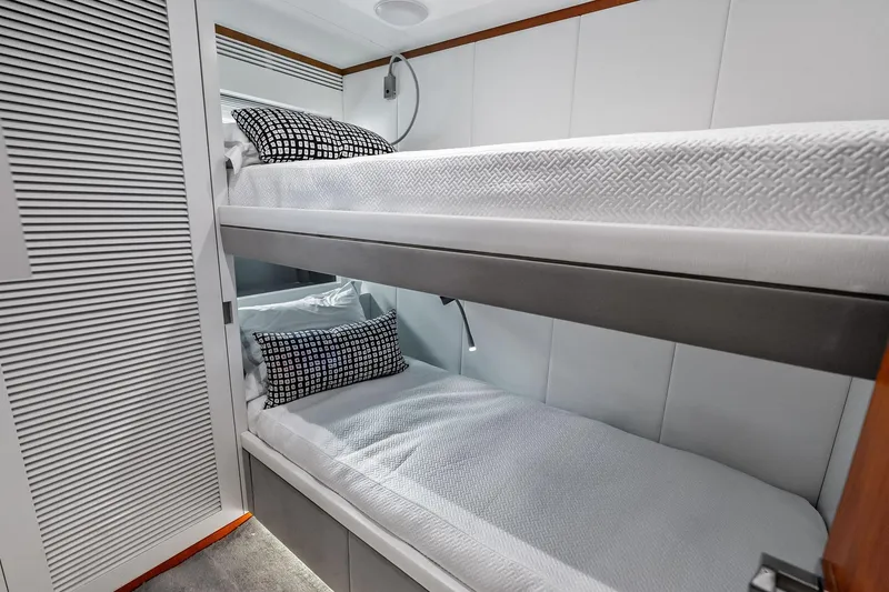 Slide: The Image of Bunk beds in 2013 AB 116 Motoryacht cabin with modern decor and patterned pillows. - 66