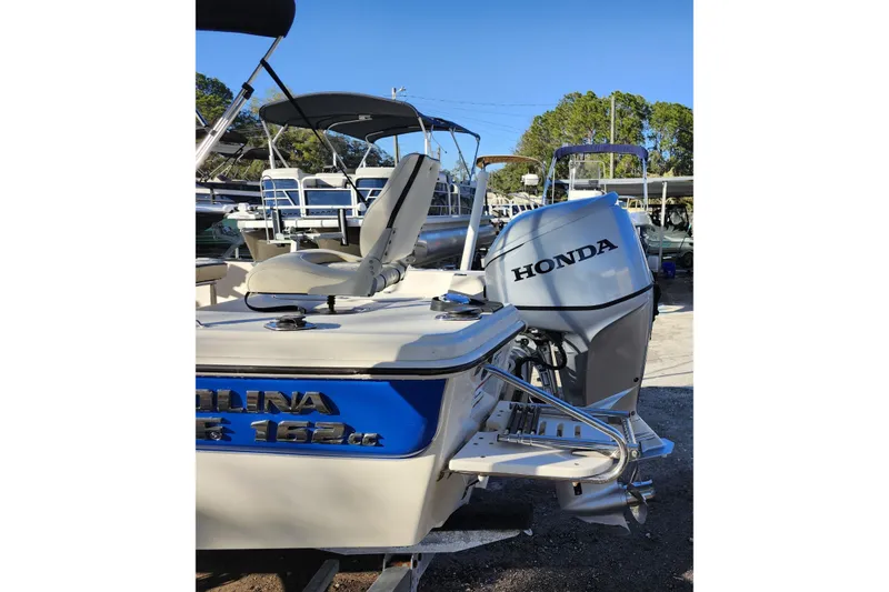 Slide: The Image of 2020 Carolina Skiff 162 JLS boat with Honda outboard motor in a marina. - 10