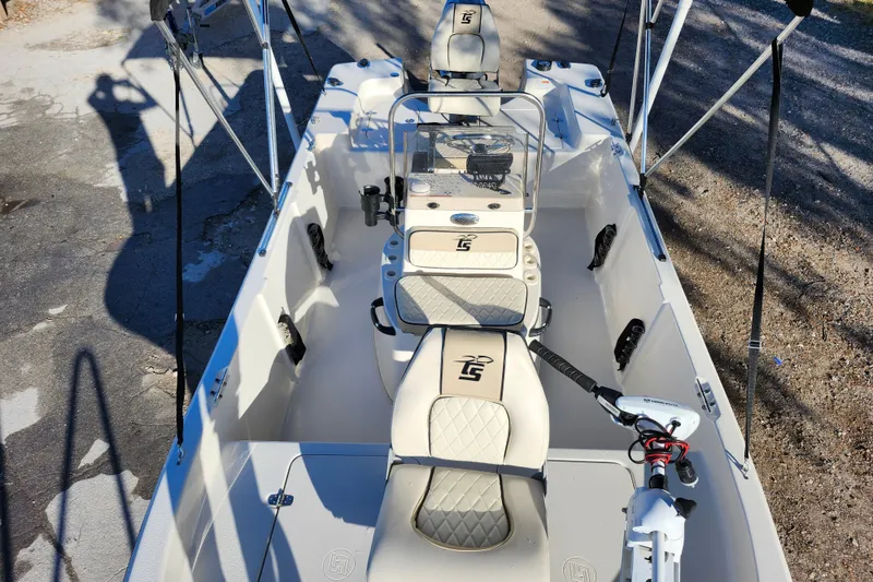 Slide: The Image of 2020 Carolina Skiff 162 JLS boat interior with seating and steering console. - 12