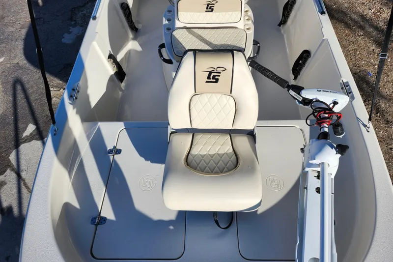 Slide: The Image of 2020 Carolina Skiff 162 JLS boat interior with seating and motor controls. - 13