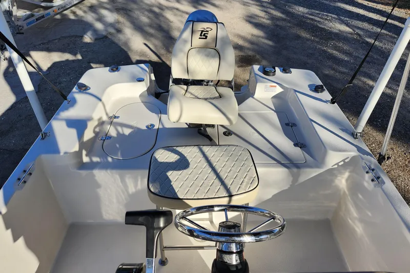 Slide: The Image of 2020 Carolina Skiff 162 JLS boat interior with steering wheel and seating. - 18