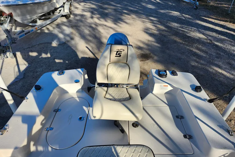 Slide: The Image of 2020 Carolina Skiff 162 JLS boat interior with seating and storage compartments. - 21