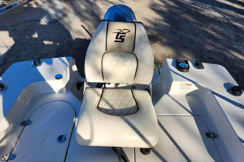 Slide: The Image of 2020 Carolina Skiff 162 JLS boat interior with cushioned seating and storage compartments. - 22