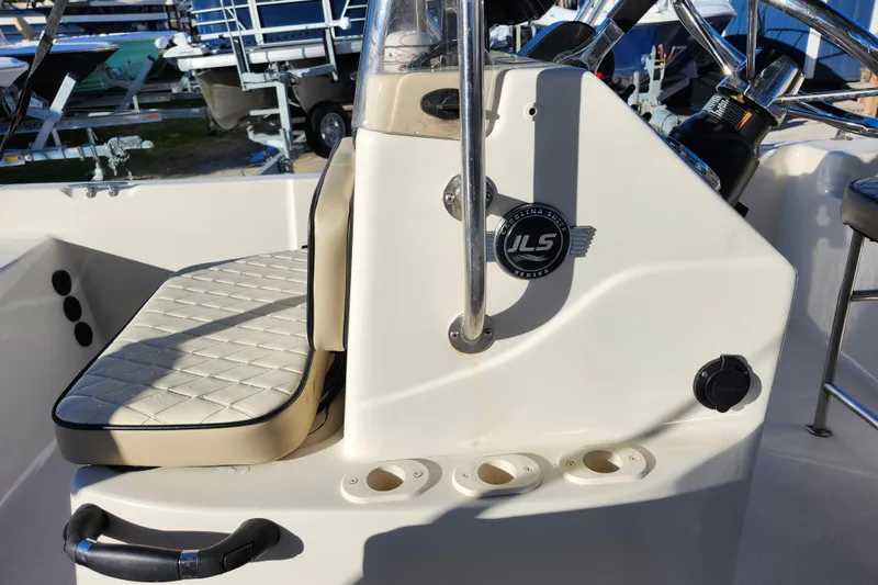 Slide: The Image of 2020 Carolina Skiff 162 JLS boat console with seating and steering wheel. - 25