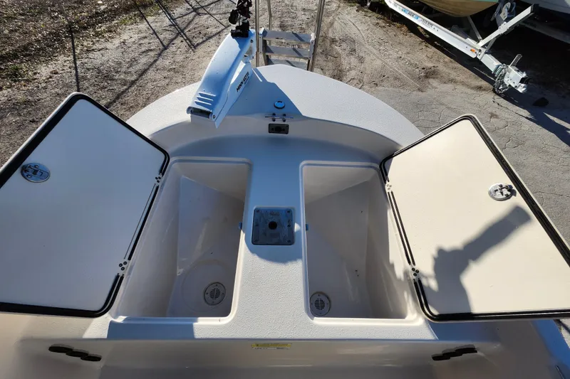 Slide: The Image of 2020 Carolina Skiff 162 JLS boat with open storage compartments on deck. - 26