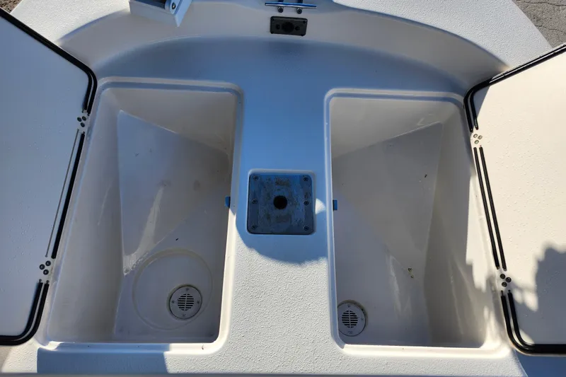Slide: The Image of 2020 Carolina Skiff 162 JLS boat storage compartments, open and empty. - 27