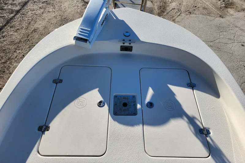 Slide: The Image of 2020 Carolina Skiff 162 JLS boat deck with storage compartments and trolling motor. - 28