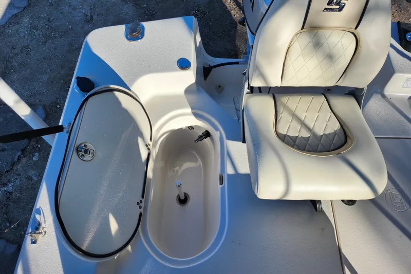 Slide: The Image of 2020 Carolina Skiff 162 JLS boat interior with seating and storage compartment. - 29