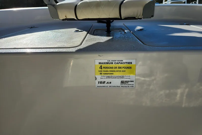 Slide: The Image of 2020 Carolina Skiff 162 JLS boat capacity label, showing maximum weight and passenger limits. - 31