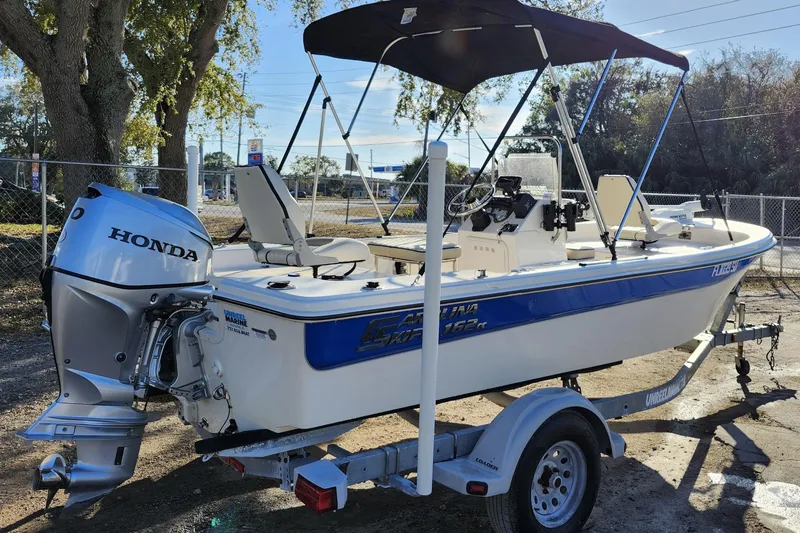 Slide: The Image of 2020 Carolina Skiff 162 JLS boat with Honda outboard motor on trailer. - 8