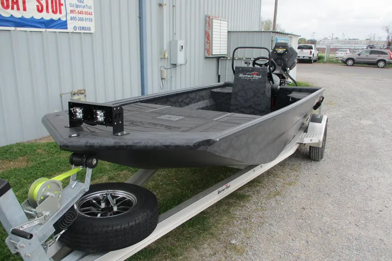 Slide: The Image of 2026 Gatortail 1860 EXTREME C.C. boat on trailer, parked outside a building. - 2