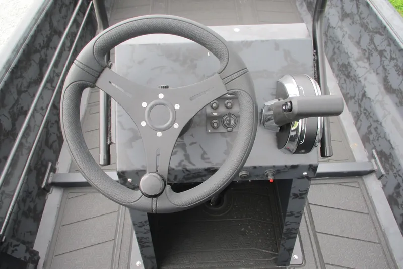 Slide: The Image of Steering console of 2026 Gatortail 1860 EXTREME C.C. boat with controls and steering wheel. - 9