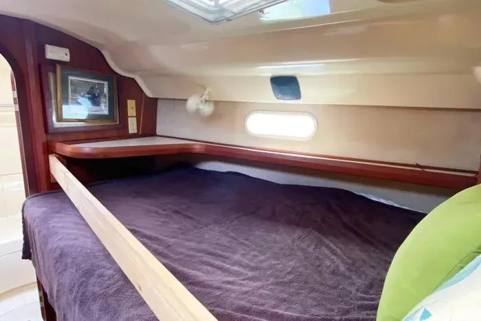 Slide: The Image of Cozy cabin interior of 1997 Hunter 430 sailboat with bed and window. - 12