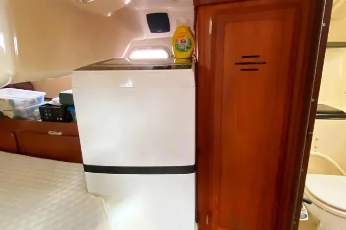 Slide: The Image of Interior of 1997 Hunter 430 yacht with washing machine and wooden cabinet. - 17