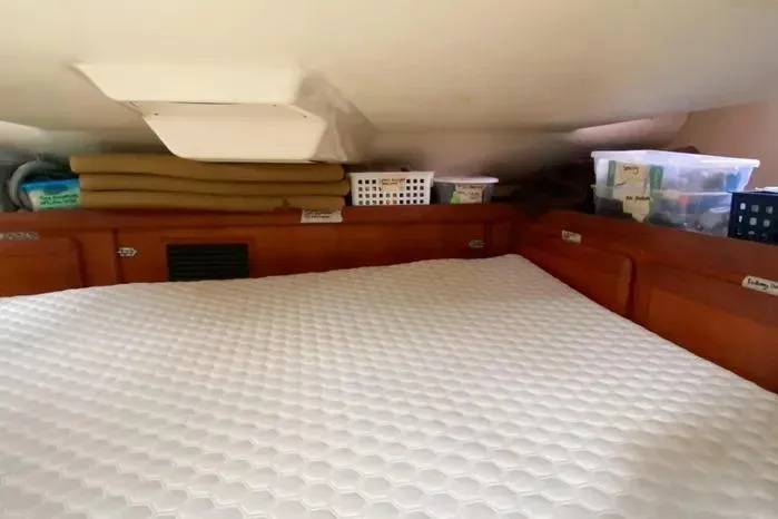 Slide: The Image of Cozy cabin interior of 1997 Hunter 430 sailboat with storage and bedding. - 18