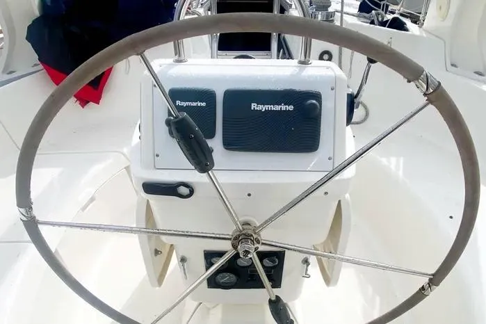 Slide: The Image of Steering wheel of a 1997 Hunter 430 sailboat with Raymarine navigation equipment. - 22
